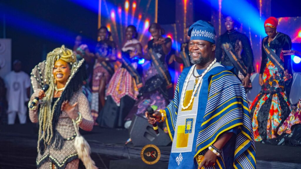 Michael Adangba performing on stage with his daughter Enam
