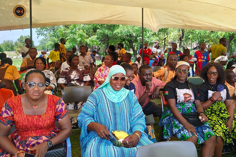 Community members gathered under a canopy at Pikworo, Paga